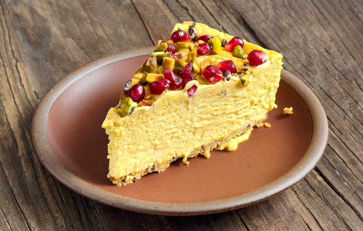 Slice of Tahini, Saffron, and Pomegranate Cheesecake