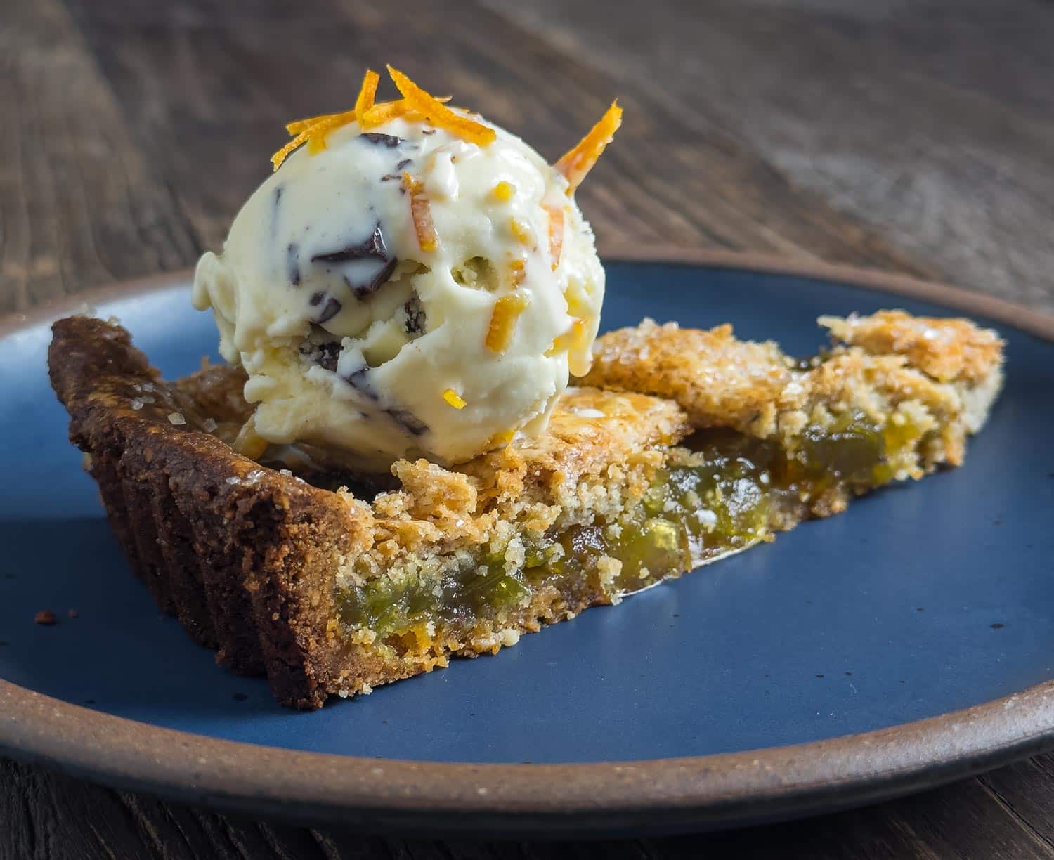 Slice of Green Tomato and Almond Tart with Crème Fraîche, Orange, and Chocolate Ice Cream